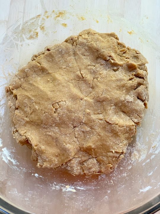 ingredients for peanut butter and pumpkin dog treats in large mixing bowl